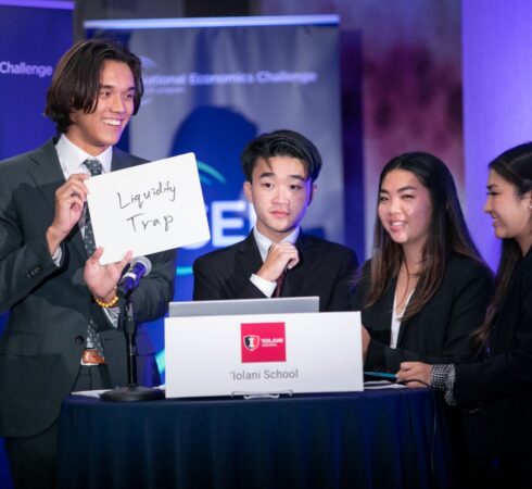Contestant holding card at Economic Challenge