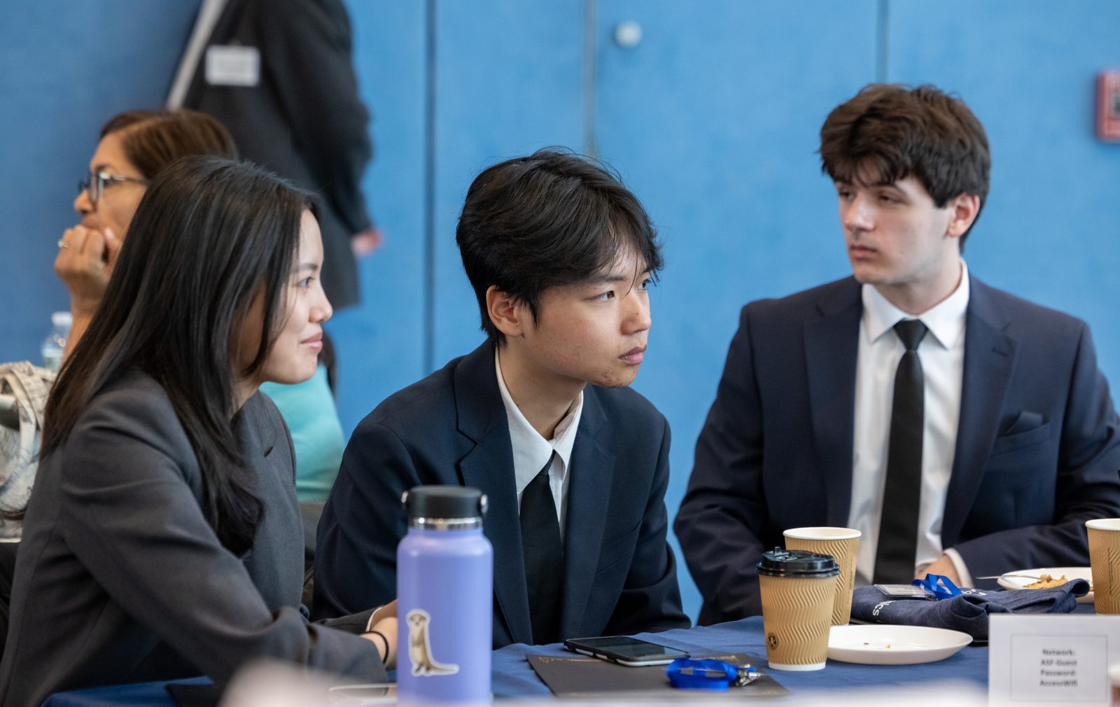 High school students in business attire compete at a CEE event